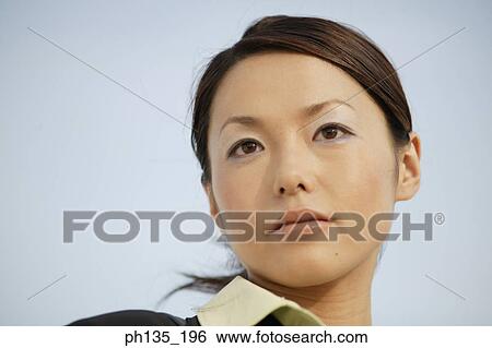 Close-up of a young businesswoman looking ahead View Large Photo Image Stock Photograph - Close-up of a young businesswoman looking ahead. Fotosearch