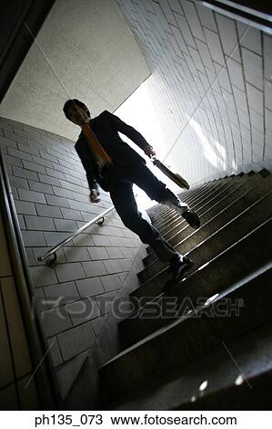 Low angle view of a young businessman coming down a flight of stairs View Large Photo Image Stock Image - Low angle view of a young businessman coming down a flight of stairs. Fotosearch