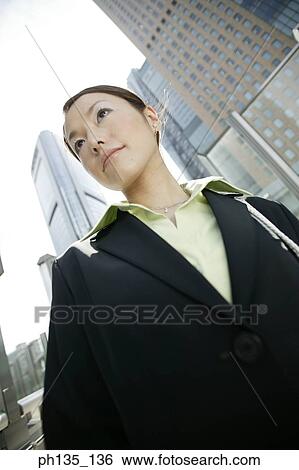 Stock Photograph - Low angle view of a young businesswoman. Fotosearch