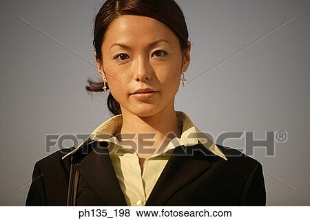 Profile of a young businesswoman looking at camera View Large Photo Image Stock Photo - Profile of a young businesswoman looking at camera. Fotosearch