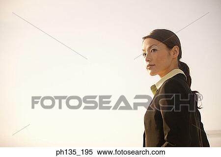 Stock Photography - Side profile of a young businesswoman. Fotosearch