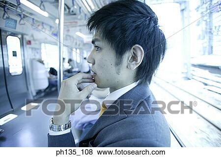 Young businessman in a train View Large Photo Image Stock Photo - Young businessman in a train. Fotosearch