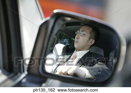 Young businessman sitting in his car View Large Photo Image Stock Image - Young businessman sitting in his car. Fotosearch