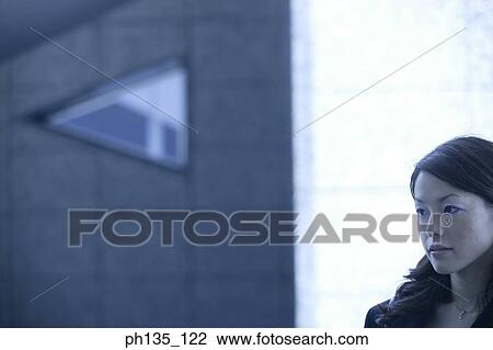 Stock Image - Young businesswoman looking ahead. Fotosearch