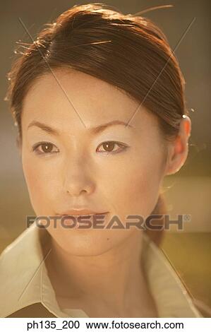 Stock Image - Young businesswoman looking ahead. Fotosearch