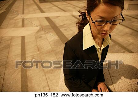 Young businesswoman sitting outdoors View Large Photo Image Stock Image - Young businesswoman sitting outdoors. Fotosearch