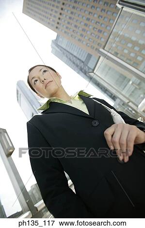 Young businesswoman standing outdoors View Large Photo Image Stock Photo - Young businesswoman standing outdoors. Fotosearch