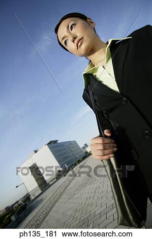 Young businesswoman standing with a shoulder bag View Large Photo Image Stock Image - Young businesswoman standing with a shoulder bag. Fotosearch