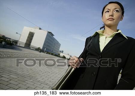 Young businesswoman standing with a shoulder bag View Large Photo Image Stock Image - Young businesswoman standing with a shoulder bag. Fotosearch