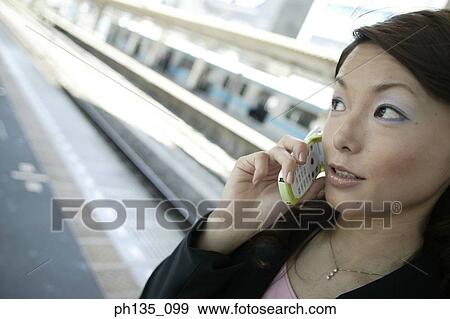Young businesswoman talking on a mobile phone View Large Photo Image Stock Photo - Young businesswoman talking on a mobile phone. Fotosearch