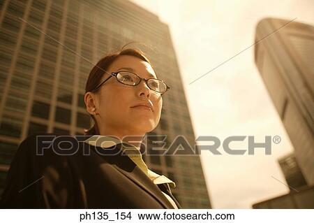 Young businesswoman wearing eye glasses looking ahead View Large Photo Image Picture - Young businesswoman wearing eye glasses looking ahead. Fotosearch