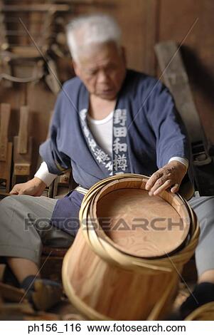 Carpenter looking at a barrel View Large Photo Image Stock Photograph - Carpenter looking at a barrel. Fotosearch
