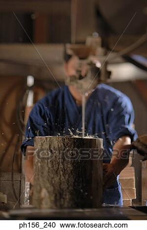 Stock Image - Carpenter working in a workshop. Fotosearch