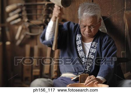Close-up of a carpenter holding a mallet View Large Photo Image Stock Photo - Close-up of a carpenter holding a mallet. Fotosearch