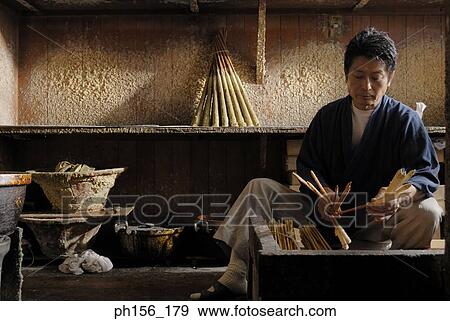 Close-up of a mid adult man making candles in a workshop View Large Photo Image Stock Photo - Close-up of a mid adult man making candles in a workshop. Fotosearch