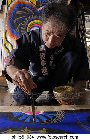Picture - Close-up of a painter painting on a sheet. Fotosearch