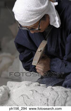 Close-up of a sculptor carving a stone View Large Photo Image Picture - Close-up of a sculptor carving a stone. Fotosearch