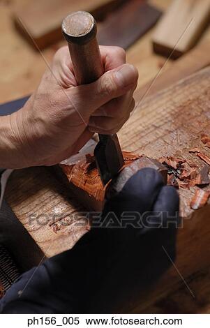 Close-up of person's hand working with a chisel View Large Photo Image Stock Photography - Close-up of person's hand working with a chisel. Fotosearch