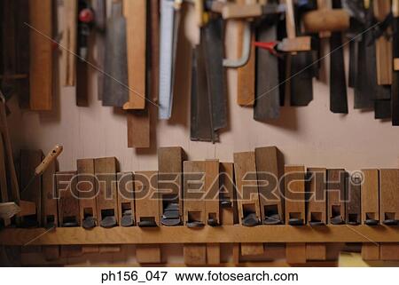Stock Photo - Close-up of work tools hanging on a wall. Fotosearch