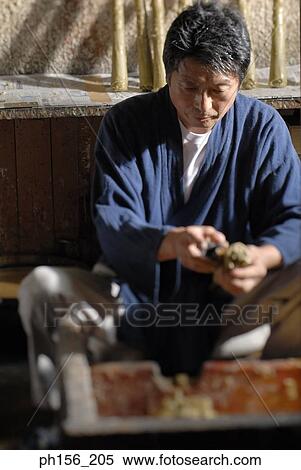 Mid adult man shaping a candle View Large Photo Image Stock Photography - Mid adult man shaping a candle. Fotosearch