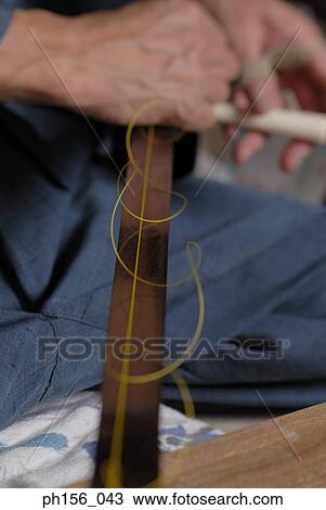 Stock Image - Mid section view of a carpenter making a samisen. Fotosearch