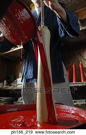 Stock Photo - Mid section view of a person pouring paint on a candle. Fotosearch