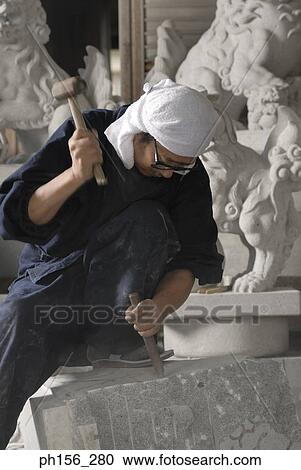 Sculptor carving a stone with a chisel and a hammer View Large Photo Image Stock Image - Sculptor carving a stone with a chisel and a hammer. Fotosearch