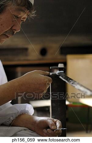 Side profile of a blacksmith applying a coating of chrome on a sword View Large Photo Image Stock Photo - Side profile of a blacksmith applying a coating of chrome on a sword. Fotosearch