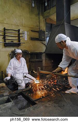 Two blacksmiths working in a workshop View Large Photo Image Stock Photo - Two blacksmiths working in a workshop. Fotosearch