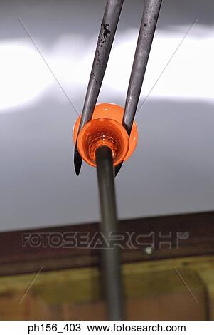 Stock Image - Close-up of a glass bulb at the end of a blow pipe. Fotosearch