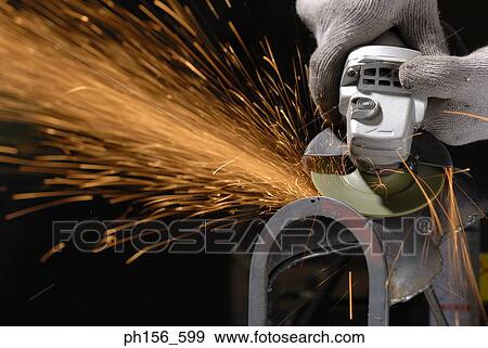 Stock Photo - Close-up of a grinder working in a workshop. Fotosearch