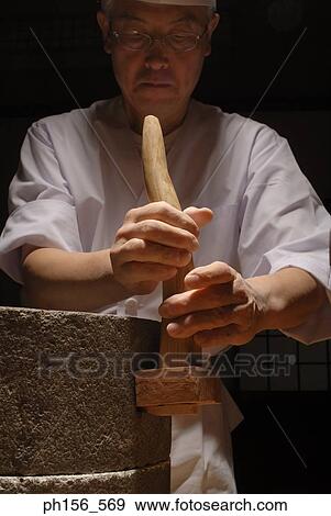 Close-up of a mature man adjusting handle of a grinding stone View Large Photo Image Stock Photo - Close-up of a mature man adjusting handle of a grinding stone. Fotosearch