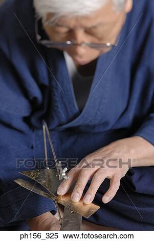 Close-up of a person cutting a metal sheet with a hacksaw blade View Large Photo Image Stock Photography - Close-up of a person cutting a metal sheet with a hacksaw blade. Fotosearch