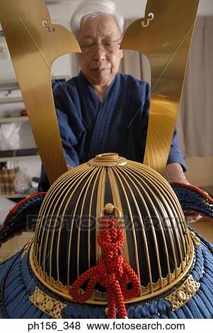 Stock Photo - Close-up of a person making a suit of armor. Fotosearch