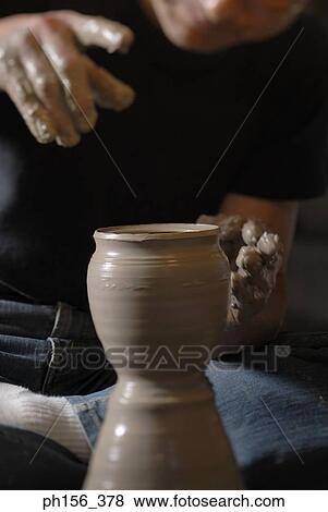 Stock Photo - Close-up of a potter making a vase. Fotosearch