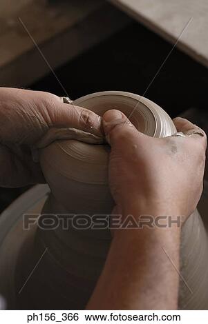 Stock Photograph - Close-up of a potter's hands making pottery. Fotosearch