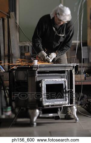 Grinder grinding in a workshop View Large Photo Image Stock Image - Grinder grinding in a workshop. Fotosearch