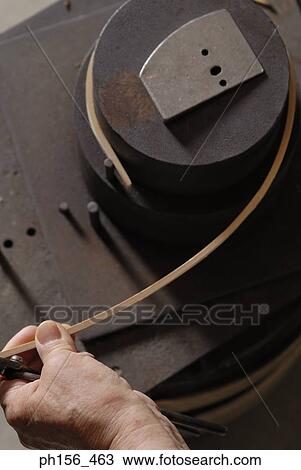 High angle view of a person's hand bending a wooden strip with the help of a pair of pliers View Large Photo Image Stock Image - High angle view of a person's hand bending a wooden strip with the help of a pair of pliers. Fotosearch