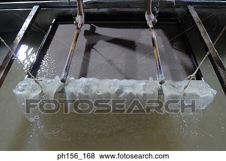 High angle view of a person's hands making candles in a factory View Large Photo Image Stock Photo - High angle view of a person's hands making candles in a factory. Fotosearch