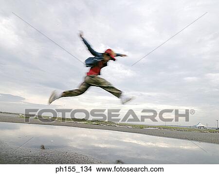 Side profile of a child jumping in air View Large Photo Image Picture - Side profile of a child jumping in air. Fotosearch