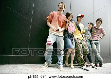Two young women and three young men standing together View Large Photo Image Picture - Two young women and three young men standing together. Fotosearch