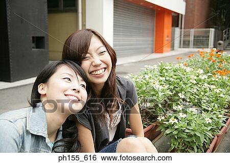 Two young women smiling View Large Photo Image Stock Photograph - Two young women smiling. Fotosearch