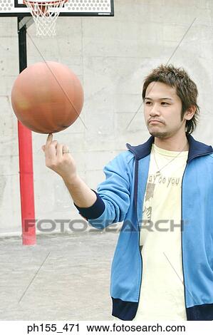 Close-up of a young man spinning a basketball View Large Photo Image Stock Image - Close-up of a young man spinning a basketball. Fotosearch