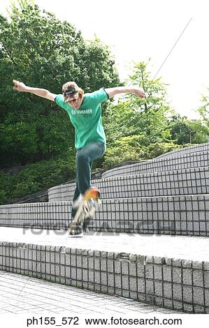 Stock Image - Low angle view of a boy skateboarding. Fotosearch