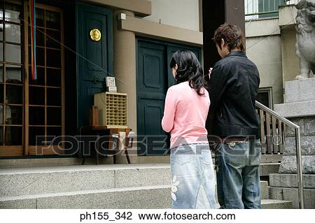 Rear view of a young couple praying View Large Photo Image Stock Image - Rear view of a young couple praying. Fotosearch
