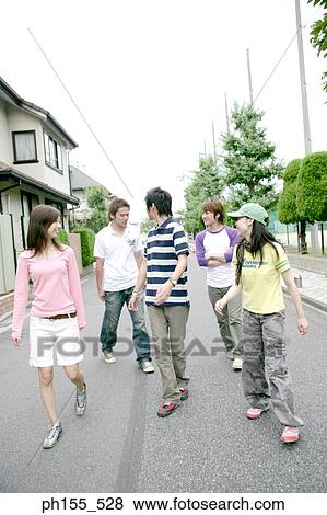 Three young men and two young women walking View Large Photo Image Stock Photo - Three young men and two young women walking. Fotosearch