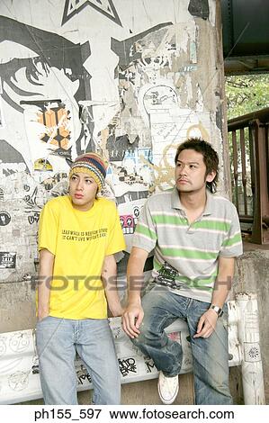 Stock Photo - Two young men looking sideways. Fotosearch