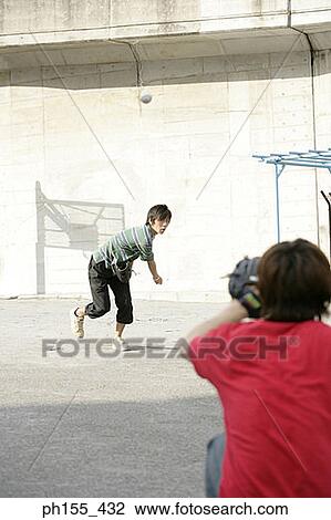 Two young men playing baseball View Large Photo Image Stock Image - Two young men playing baseball. Fotosearch