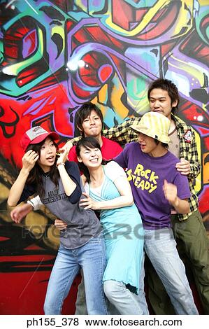 Stock Photo - Two young women and three young men playing. Fotosearch