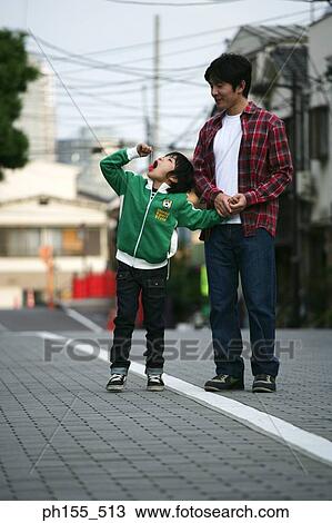 Young man standing and holding his father's hand View Large Photo Image Stock Image - Young man standing and holding his father's hand. Fotosearch
